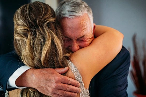 bride and dad hugging